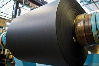 The enormous rolls of paper are formed onto the end of the machine.