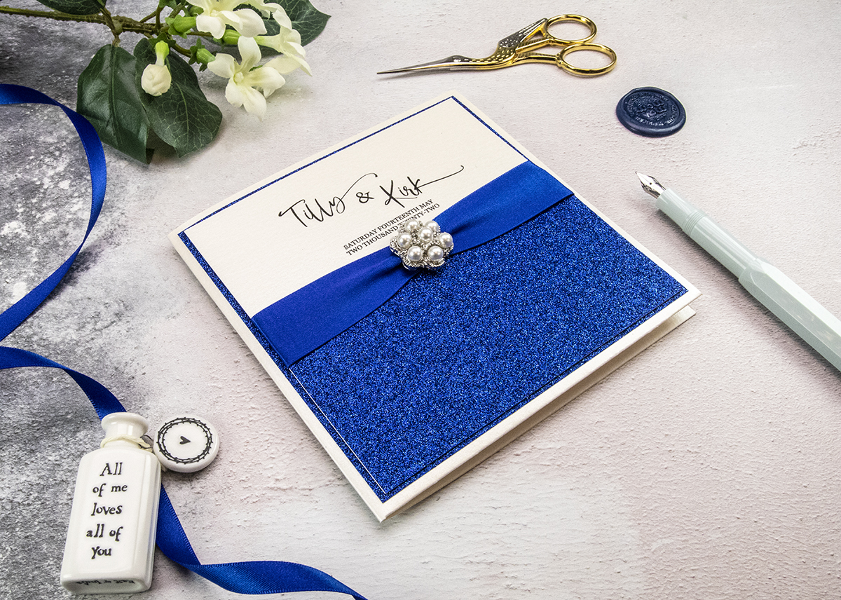 Beautiful wedding invitation with royal blue glitter.