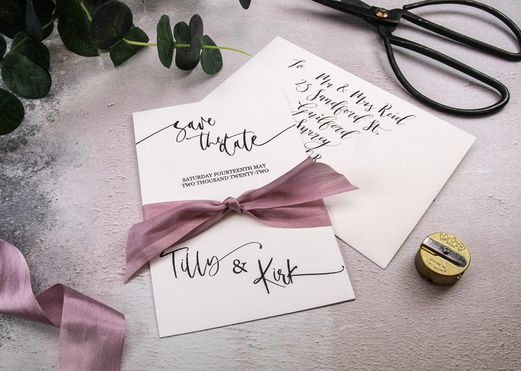 Save the Date cards with rose silk ribbon.