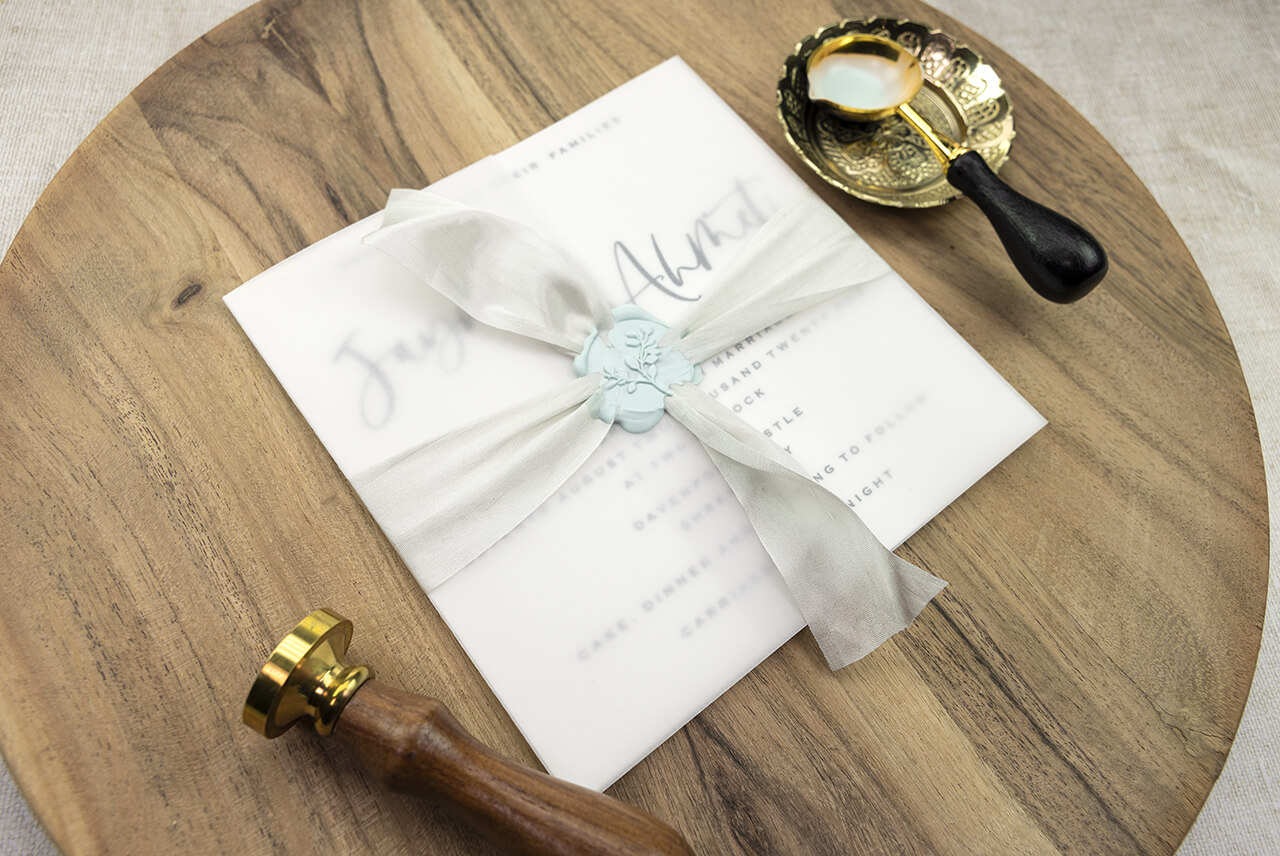 Wax seals used to seal silk ribbon on a wedding invitation